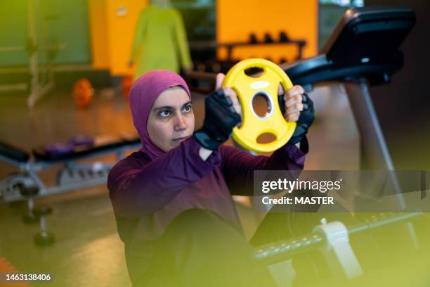 muslim woman working out in open gym - veil stock pictures, royalty-free photos & images