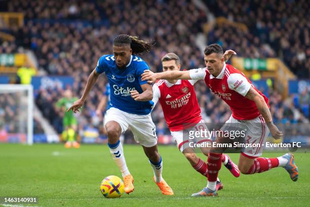Alex Iwobi of Everton challenges for the ball with Granit Xhaka during the Premier League match between Everton FC and Arsenal FC at Goodison Park on...
