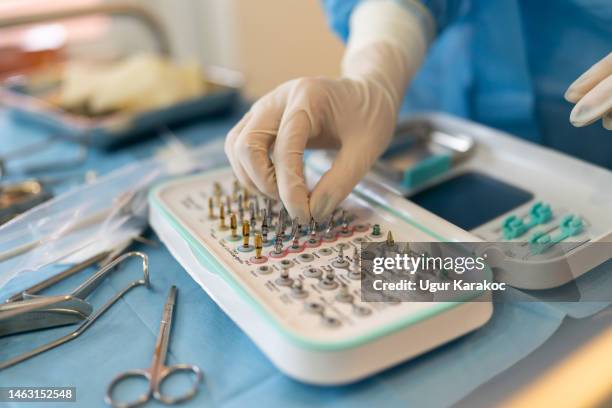 female medical assistance preparing dental equipments, orthodontist clinic - tandfyllning bildbanksfoton och bilder