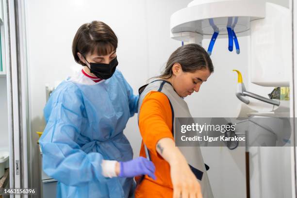 patient in x-ray machine in dental clinic, panoramic radiography - radiation shielding stock pictures, royalty-free photos & images