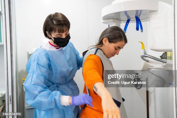 patient in x-ray machine in dental clinic, panoramic radiography - medical x ray stock pictures, royalty-free photos & images