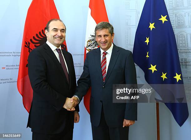 Austria's Foreign Minister Michael Spindelegger greets Albania's Deputy Prime Minister Edmond Haxhinasto during his visit to Vienna, on June 14,...