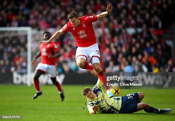 Chris Wood of Nottingham Forest battles for possession with Maximilian Woeber of Leeds United during the Premier League match between Nottingham...