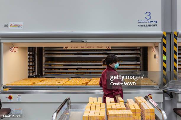 Female employee moves wax moldes into storage at the new Pandora facility in Lamphun.