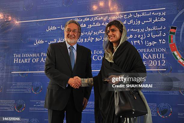 Pakistan Foreign Minister Hina Rabbani Khar shakes hands with her Afghan counterpart Zalmai Rasool before the start of the the Heart of Asia...