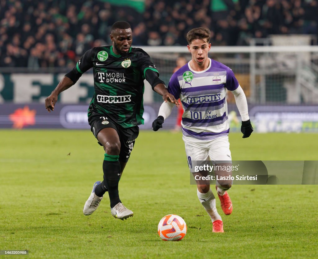 Anderson Esiti of Ferencvarosi TC challenges Luis Jakobi of Ujpest