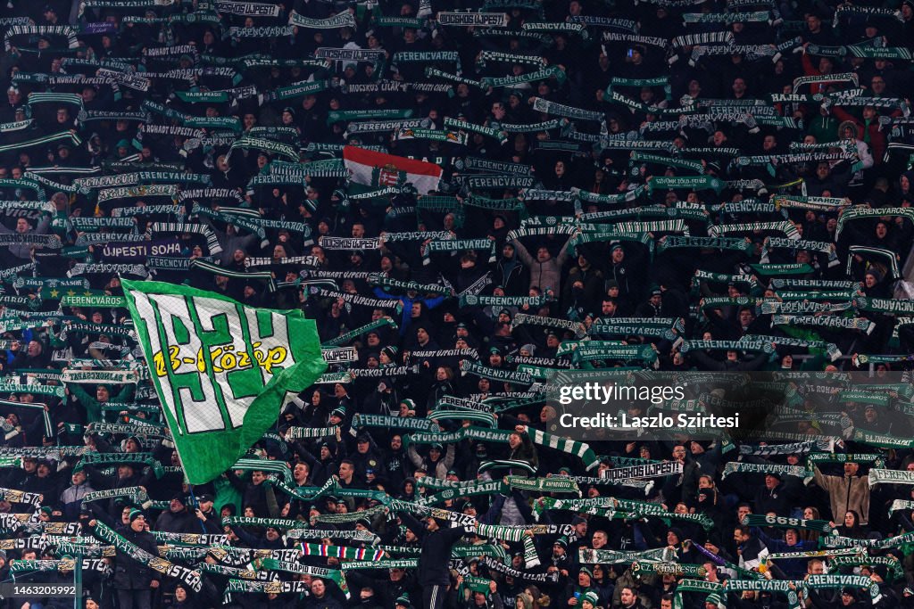 Ultra supporters of Ferencvarosi TC lift scarves over their heads
