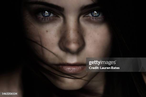 portrait of a young woman in the darkness - lauren white stock pictures, royalty-free photos & images