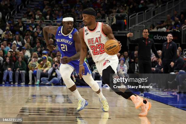 Jimmy Butler of the Miami Heat is defended by Jrue Holiday of the Milwaukee Bucks during a game at Fiserv Forum on February 04, 2023 in Milwaukee,...