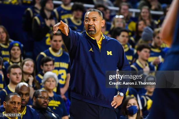 Head Basketball Coach Juwan Howard of the Michigan Wolverines signals to his team during the second half of a college basketball game against the...