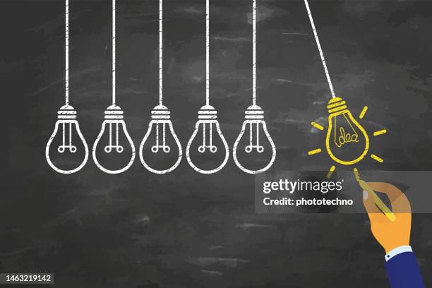 innovation concepts with light bulb on blackboard background - the new school stock illustrations