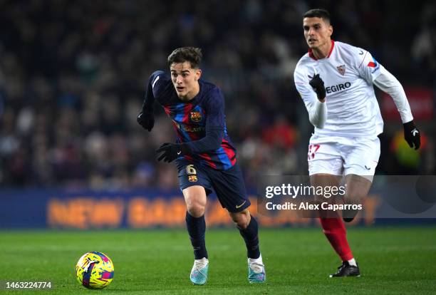 Gavi of FC Barcelona is challenged by Erik Lamela of Sevilla FC during the LaLiga Santander match between FC Barcelona and Sevilla FC at Spotify Camp...