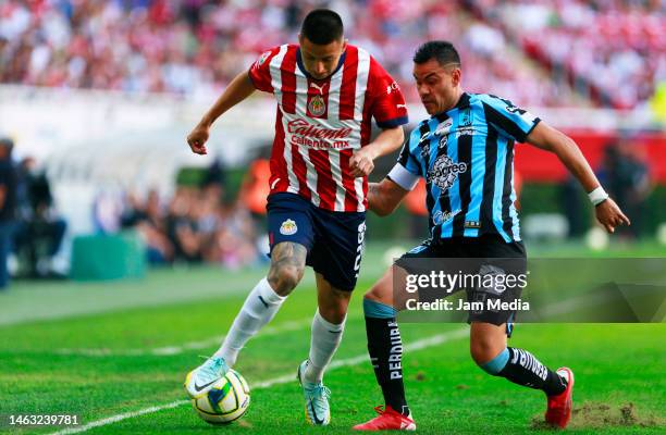 Roberto Alvarado of Chivas fights for the ball with Pablo Barrera of Queretaro during the 5th round match between Chivas and Queretaro as part of the...