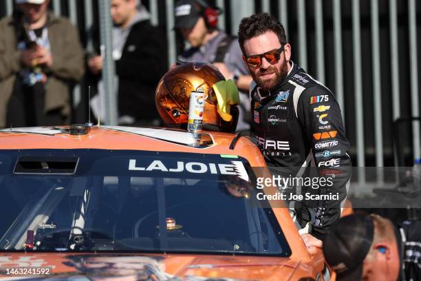 Corey LaJoie, driver of the Animal Control FOX Chevrolet, enters his car to race qualifying heat for the NASCAR Clash at the Coliseum at Los Angeles...