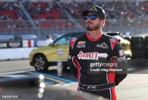 Yeley, driver of the CW & Sons Infrastructure Ford, looks on during qualifying heats for the NASCAR Clash at the Coliseum at Los Angeles Memorial...