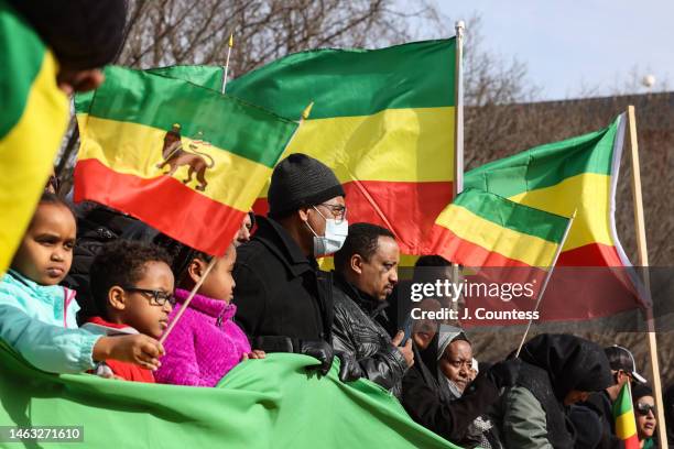 Parishioners and supporters of the Ethiopian Orthodox Church line up behind an Ethiopian flag banner during a demonstration at the White House on...