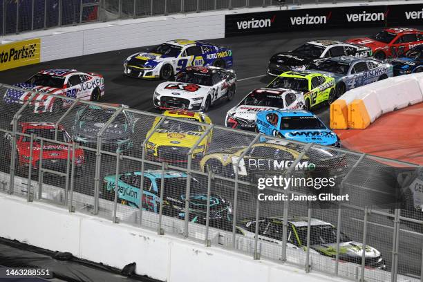 Kyle Busch, driver of the BetMGM Chevrolet, spins after an on-track incident as Joey Logano, driver of the Shell Pennzoil Ford, and Ross Chastain,...