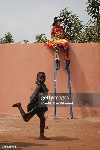 Stilted dancer takes a break before performing at a Voodoo Ceremony on January 9, 2012 in Ouidah, Benin. Ouidah is Benin's Voodoo heartland, and...