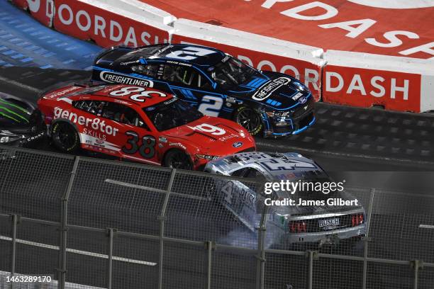 Kevin Harvick, driver of the Busch Light Ford, spins after an on-track incident in front of Todd Gilliland, driver of the gener8tor Skills Ford, and...