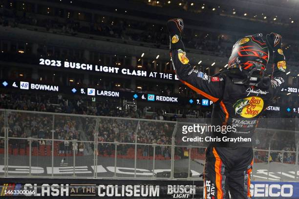 Martin Truex Jr., driver of the Bass Pro Shops Toyota, celebrates after winning the NASCAR Clash at the Coliseum at Los Angeles Memorial Coliseum on...