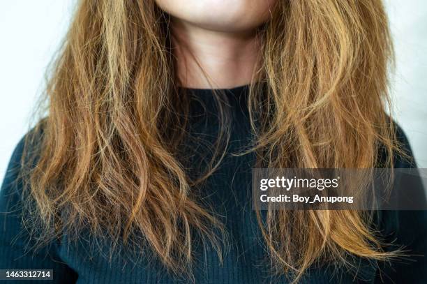 cropped shot view of woman with her damaged split ended and messy hair. - frizzy stock pictures, royalty-free photos & images