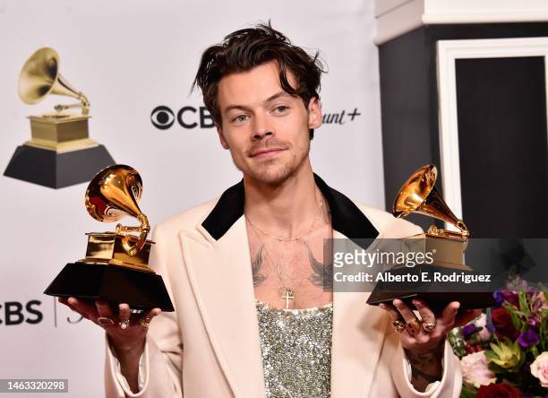 Harry Styles poses with the Best Pop Vocal Album Award for “Harry’s House” and Album of the Year Award for “Harry’s House” in the press room during...