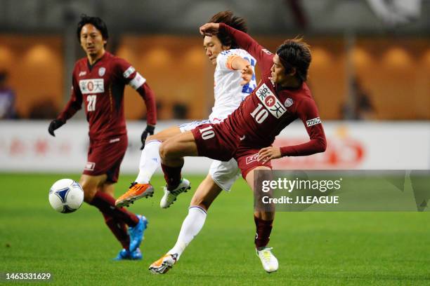 Shunsuke Nakamura of Yokohama F.Marinos and Yoshito Okubo of Vissel Kobe compete for the ball during the J.League J1 match between Vissel Kobe and...