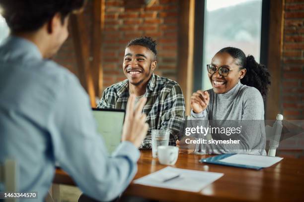 happy black couple talking to their agent in the office. - bankers stock pictures, royalty-free photos & images