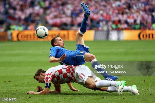 Emanuele Giaccherini of Italy clashes with Darijo Srna of Croatia during the UEFA EURO 2012 group C match between Italy and Croatia at The Municipal...