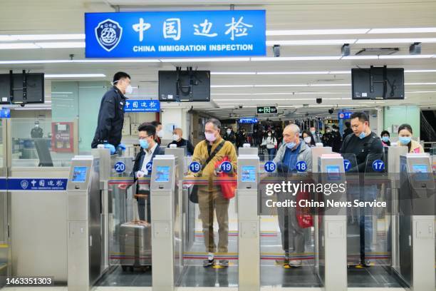 Travelers queue to pass automated gates at the Lo Wu checkpoint as cross-border travel has been fully resumed on February 6, 2023 in Shenzhen,...