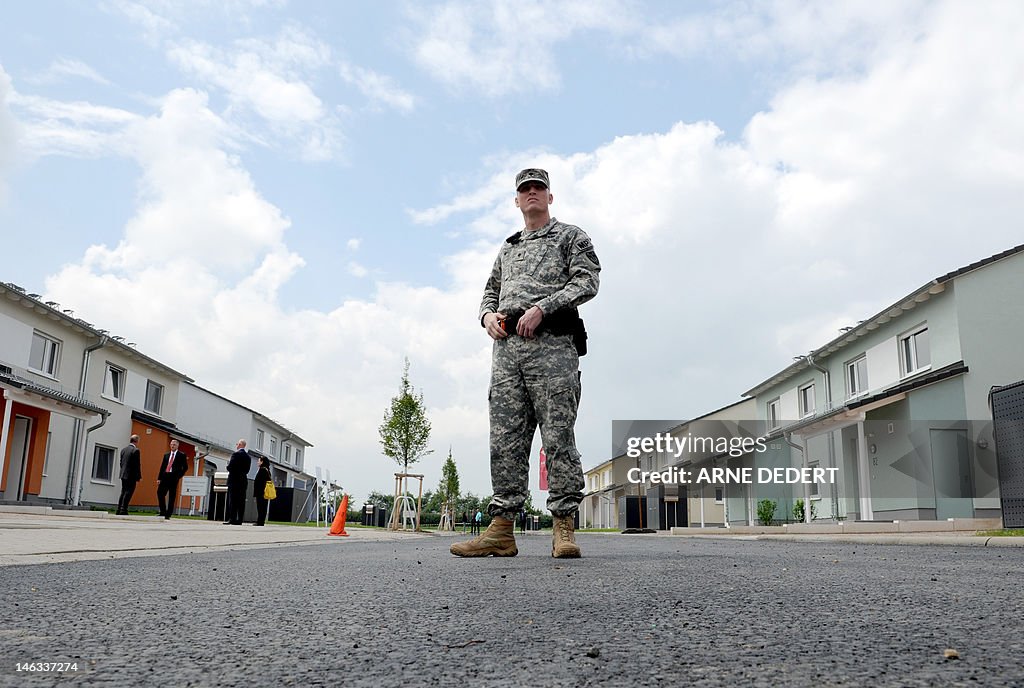 A US soldier stands in front of the hous