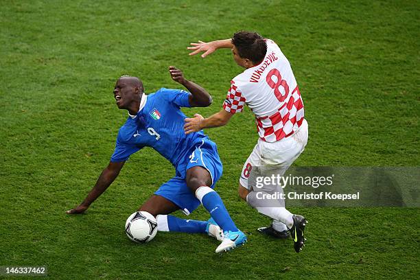 Mario Balotelli of Italy clashes with Ognjen Vukojevic of Croatia during the UEFA EURO 2012 group C match between Italy and Croatia at The Municipal...