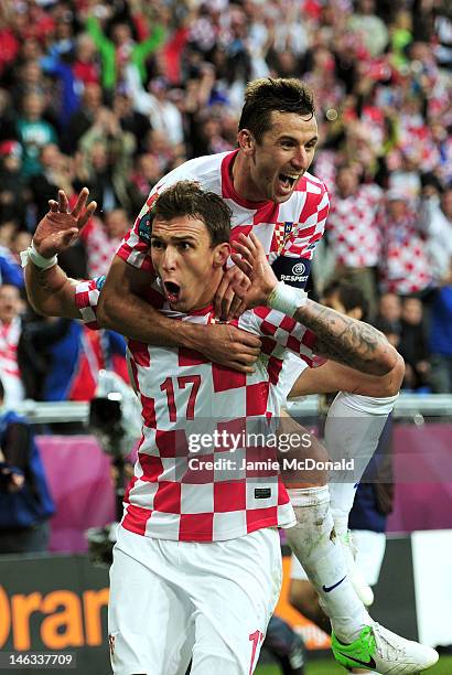 Mario Mandzukic of Croatia celebrates scoring their first goal with Darijo Srna of Croatia during the UEFA EURO 2012 group C match between Italy and...