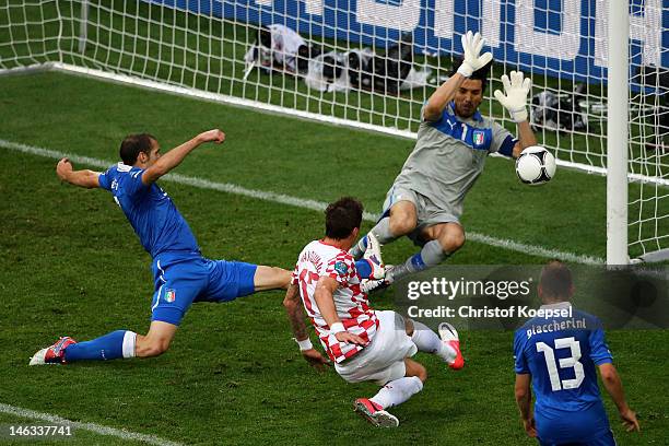 Mario Mandzukic of Croatia scores the opening goal past Gianluigi Buffon of Italy during the UEFA EURO 2012 group C match between Italy and Croatia...