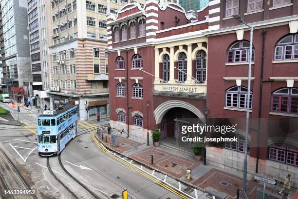 street view in western market and tram, central district, hong kong. - west front stock pictures, royalty-free photos & images