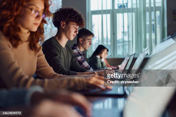 high school students e-learning over computers in the classroom. - computer lab stock pictures, royalty-free photos & images