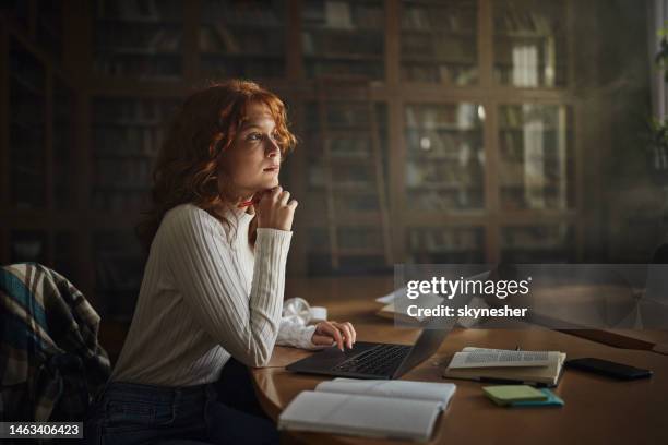 thoughtful female student e-learning in library. - introspection stock pictures, royalty-free photos & images