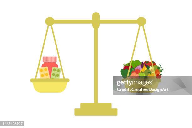 healthy foods or vitamin pills? weight scale with vitamin capsules and healthy foods - vitamin a nutrient stock illustrations