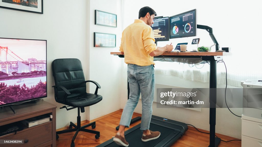 Standing desk home office with under desk treadmill