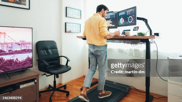 standing desk home office with under desk treadmill - practice stock pictures, royalty-free photos & images