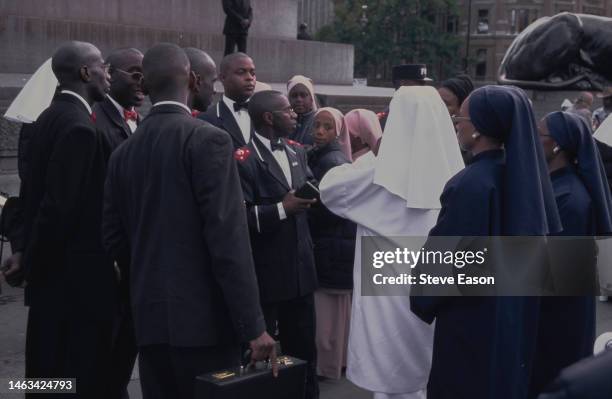 Uniformed male and female members of the Nation of Islam gather in Trafalgar Square, London, 1998.