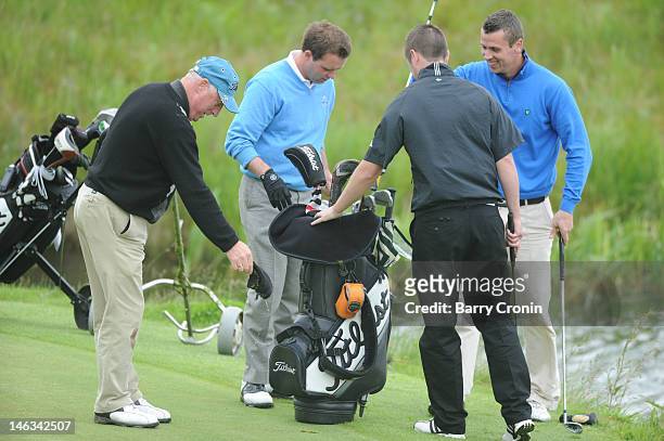 Tony Hayes and Michael Dixon of the K Club, and Derek Morrison of Foyle Golf Centre after Tony's golf trolley and clubs fell in a pond during the...