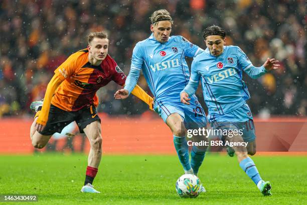 Kerem Akturkoglu of Galatasaray, Jens Stryger Larsen of Trabzonspor, Abdulkadir Omur of Trabzonspor during the Turkish Super Lig match between...