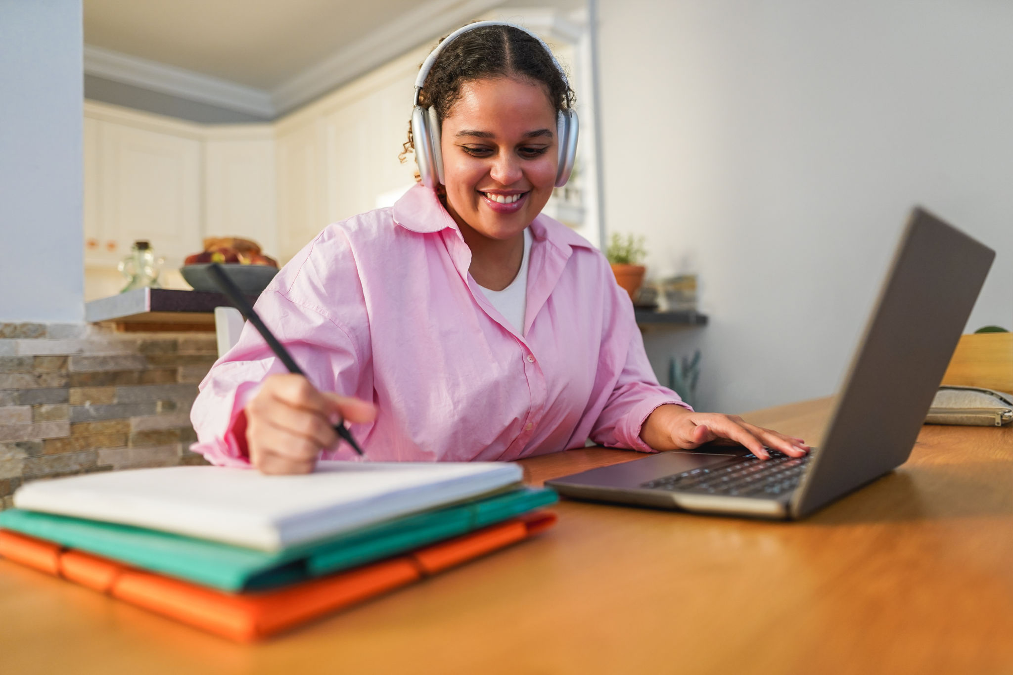 Girl using laptop computer from home while working on university project - Soft focus on face Girl using laptop computer from home while working on university project - Soft focus on face