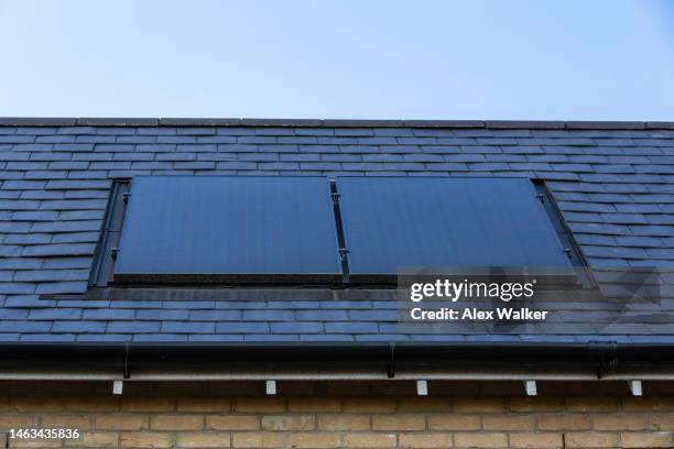 solar panels on roof of residential building - houses in the sun stock pictures, royalty-free photos & images