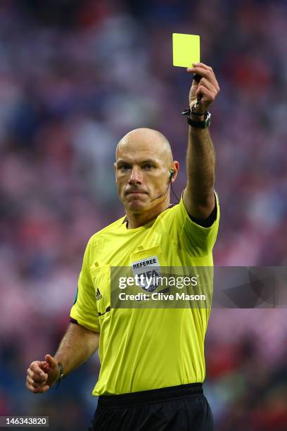 Referee Howard Webb issues a yellow card during the UEFA EURO 2012 group C match between Italy and Croatia at The Municipal Stadium on June 14, 2012...