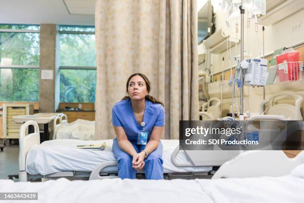 nurse sits on hospital bed to take a break - stressed student stock pictures, royalty-free photos & images