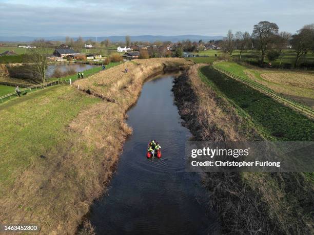 In this aerial view, search team members use sonar equipment onboard a RIB boat on February 6, 2023 in St Michael's on Wyre, England. An independent...