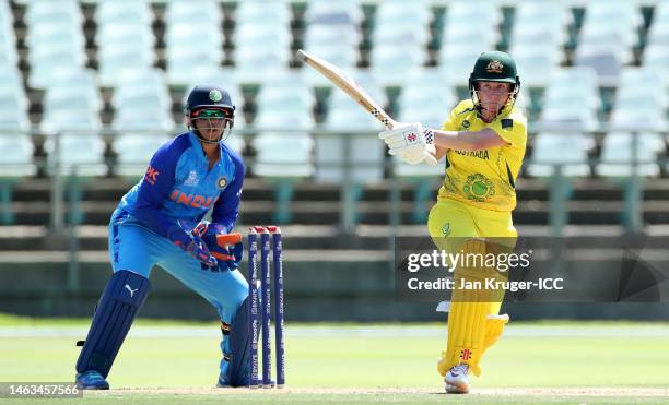 Beth Mooney of Australia plays a shot as Richa Ghosh of India keeps during a warm-up match between Australia and India prior to the ICC Women's T20...
