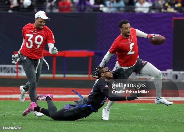 Pat Surtain II of the Denver Broncos and AFC carries the ball after intercepting a pass intended for Justin Jefferson of the Minnesota Vikings and...